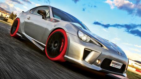 Sleek Toyota GT86 Racing Down the Road wallpaper