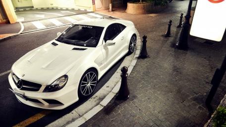 Sleek White Mercedes AMG in Urban Setting wallpaper