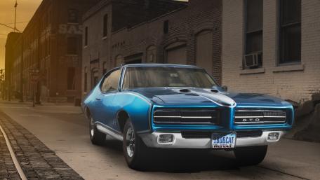 Vintage Pontiac GTO on Urban Streetscape wallpaper