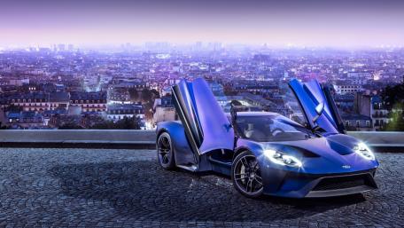 Majestic Ford GT Against a Vibrant Cityscape wallpaper