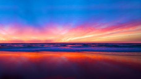 Vibrant Sunset Over Tranquil Beach Scene wallpaper