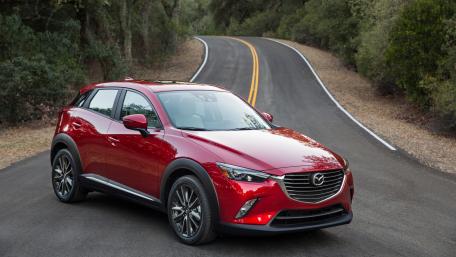 Sleek Mazda CX-3 on Serene Roadway Showcase wallpaper