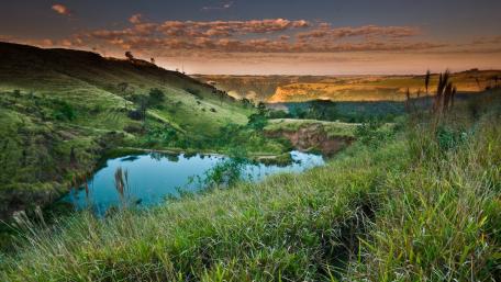 Serene Lake Nestled Among Green Hillsides wallpaper