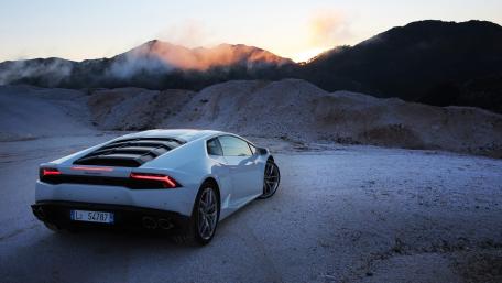 Sleek Lamborghini Against Dramatic Landscape wallpaper