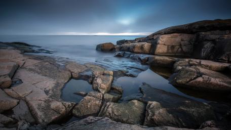 Serene Coastal View of Rocks and Water wallpaper