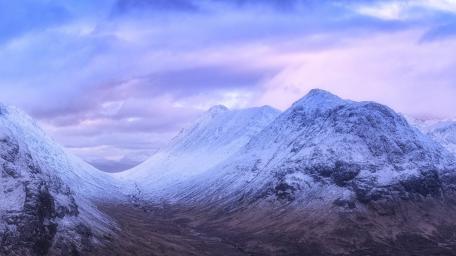 Majestic Snow-Capped Mountains Under a Dreamy Sky wallpaper