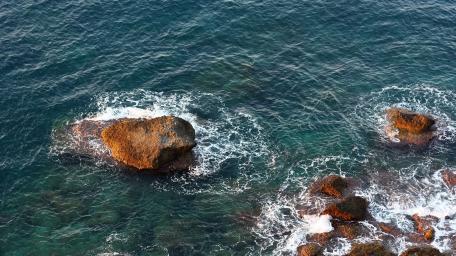 Serene Ocean Waves on Rocky Shoreline wallpaper