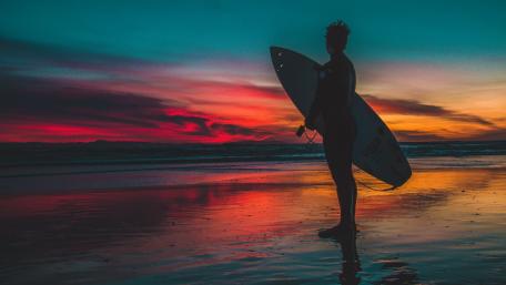 Surfing at Sunset Blissful Moments by the Shore wallpaper