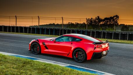 Sleek Red Chevrolet Sports Car at Sunset wallpaper