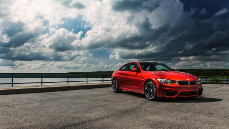 Dynamic Red BMW Series 4 Against a Dramatic Sky wallpaper