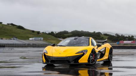 Sleek Yellow McLaren 12C on Wet Track wallpaper