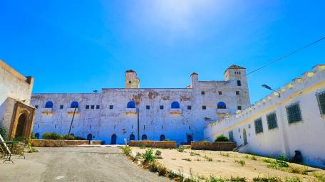 Ancient Fortress Under a Bright Blue Sky wallpaper