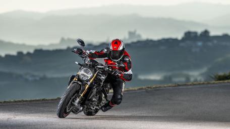 Stylish Ducati Motorcycle in Action on Curvy Road wallpaper