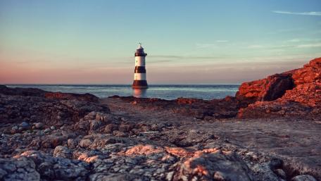 Majestic Lighthouse by the Shore wallpaper