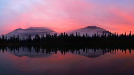 Serene Misty Mountains Under a Pink Sky wallpaper
