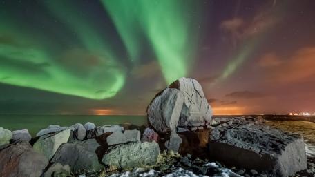 Enchanting Aurora Over Rocky Shoreline wallpaper