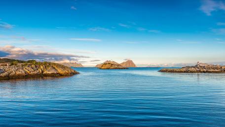 Island Serenity Under Blue Skies and Sea wallpaper