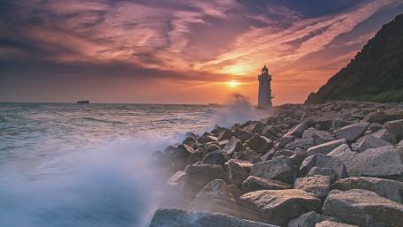 Serene Lighthouse at Sunset by the Coast wallpaper