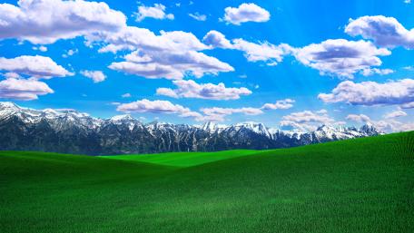 Majestic Mountains and Lush Green Plains wallpaper