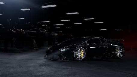 Sleek Black Lamborghini Aventador in Dramatic Garage Setting wallpaper