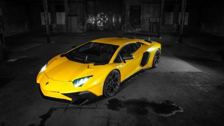 Bold Yellow Lamborghini Aventador in Industrial Setting wallpaper