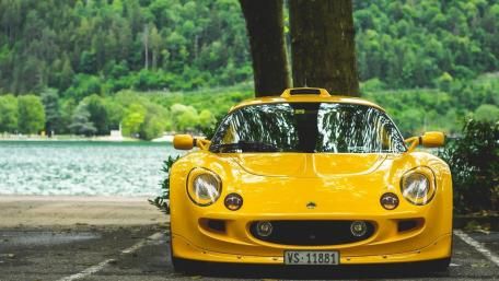 Vibrant Lotus Exige in Scenic Nature Setting wallpaper