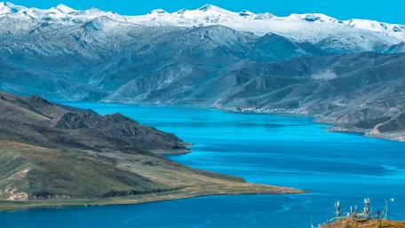 Majestic Blue Lake Surrounded by Snowy Mountains wallpaper