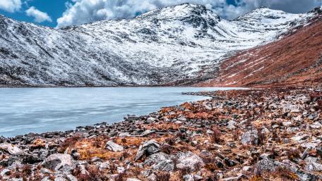 Majestic Highland Landscape with Snowy Peaks wallpaper