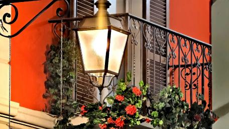 Charming Street Lanterns Illuminating Vibrant Balconies wallpaper