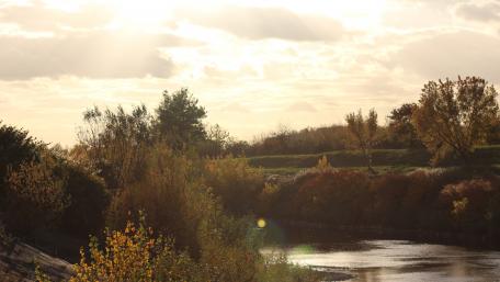 Serene River Landscape with Dramatic Clouds wallpaper