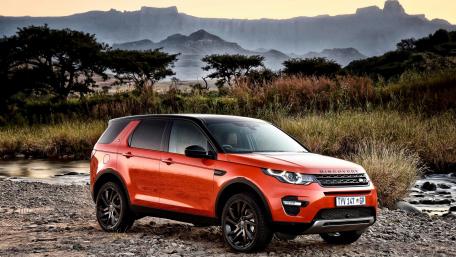Vibrant Land Rover Discovery Sport in Nature's Embrace wallpaper