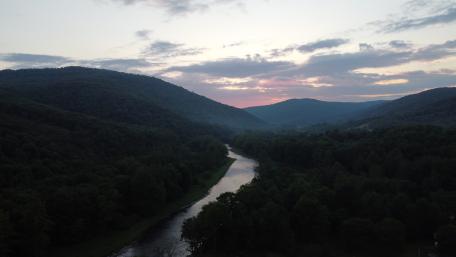 Serene River Valley in Twilight Mist wallpaper