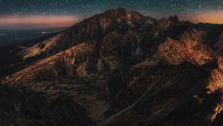 Majestic Mountain Under Starry Night Sky wallpaper