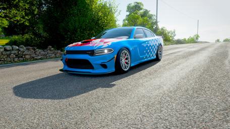 Vibrant Blue Race Car on Scenic Roadway wallpaper