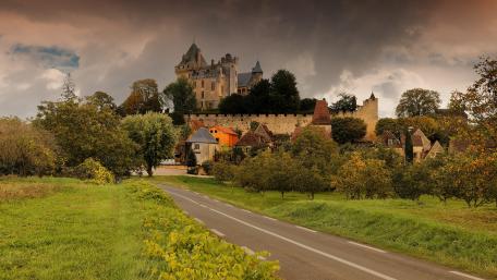 Majestic Castle Under Dramatic Clouds wallpaper