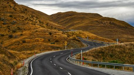 Curved Mountain Road in Scenic Landscape wallpaper