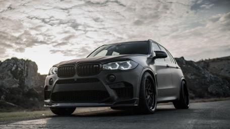 Sleek BMW X5 Against a Dramatic Sky wallpaper