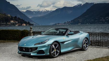 Sleek Ferrari Portofino Against Majestic Mountains wallpaper