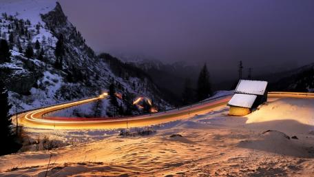 Winding Mountain Road Under Winter Lights wallpaper