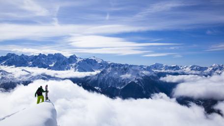 Majestic Winter Peaks and Adventurous Snowboarder wallpaper