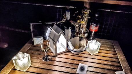 Cozy Dining Setup with Elegant Décor and Bottles of Wine wallpaper