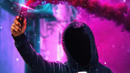 Anonymus with colorful smoke bomb wallpaper