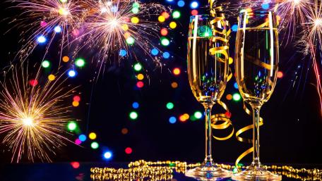 Glasses with Champagne and fireworks on New Year's Eve 2022 wallpaper