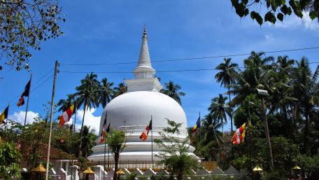 Serene Temple Stupa Amidst Tropical Bliss wallpaper