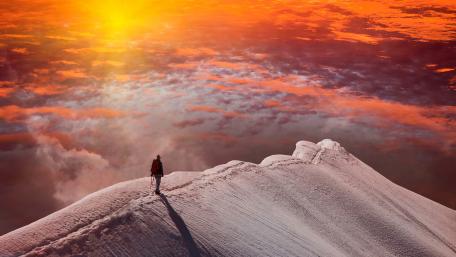 Standing at snowy peak at sunset wallpaper