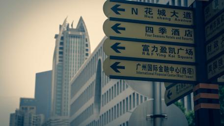 Urban Directional Signs in a Modern Cityscape wallpaper
