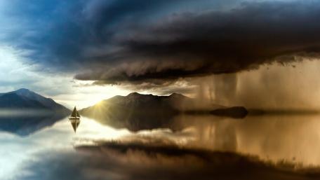 Tranquil Lake Under Dramatic Skies wallpaper