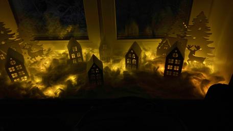 Magical Winter Village Scene with Soft Glow wallpaper