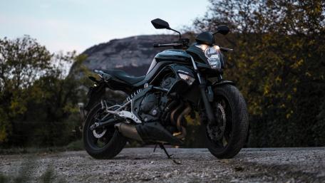Sleek Kawasaki Motorcycle on a Scenic Pathway wallpaper