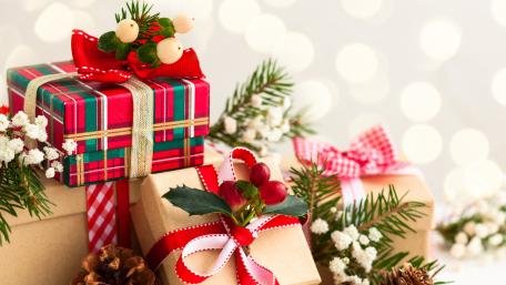 Festive Christmas Gifts Under Bright Bokeh Lights wallpaper